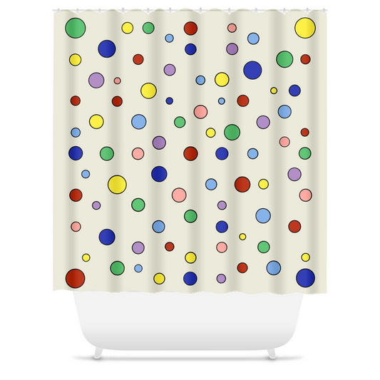 cream off-white shower curtain with brilliant, multicolored polka dots in primary and secondary colors and variable sizes irregularly dancing across. shown hung by rings over white bathtub.