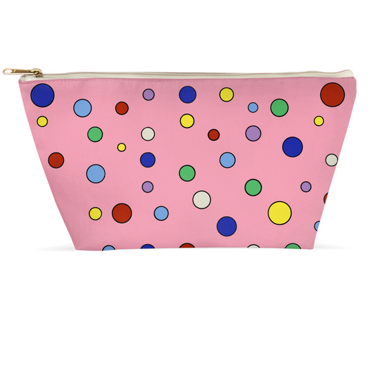 zippered pink toiletries or accessory pouch with a variable multicolor polka dot pattern of primary and secondary colors.