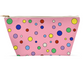 back view of multicolored polka-dotted pattern on large white-seamed gold zippered pouch.