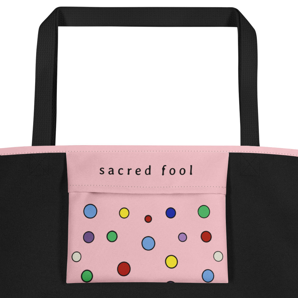 interior view of large tote's inner pocket with sacred fool's logo written in black and polka dots decorating the bottom two thirds of the pocket enclosure.