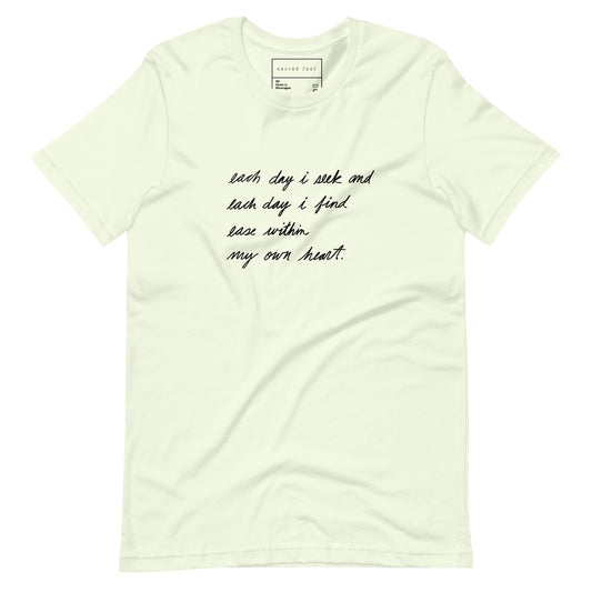 pale pastel yellow green tee shirt with poem handwritten in black cursive that says, each day i seek and each day i find ease within my own heart. by ashton guy.